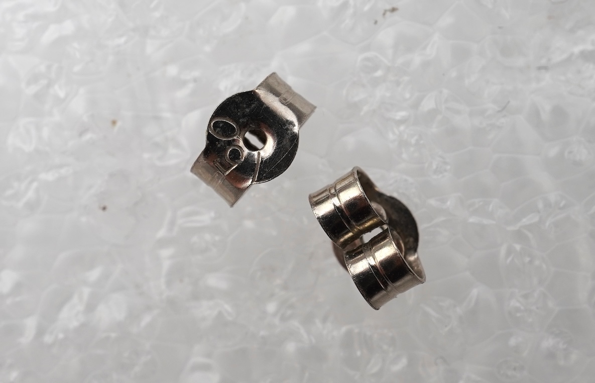 A pair of diamond stud earrings